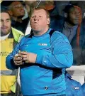  ??  ?? Sutton United substitute goalkeeper Wayne Shaw chomps on a pie during the non-league team’s FA Cup loss to Arsenal.