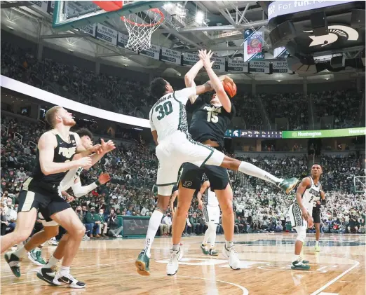  ?? REY DEL RIO/GETTY IMAGES ?? Michigan State’s Marcus Bingham Jr. blocks a shot by Purdue’s Zach Edey during the second half Saturday in East Lansing, Mich.