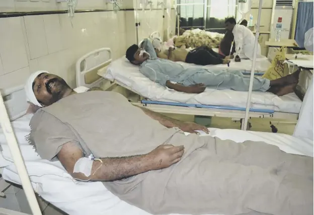  ??  ?? 0 Casualties of the attacks at the shrine near the city of Sargodha are treated in hospital. Four were said to be in critical condition