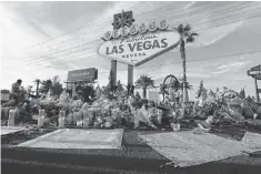  ?? JOHN LOCHER, AP ?? A makeshift memorial was started for victims of the mass shooting in Las Vegas.