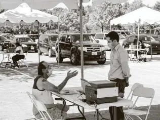  ?? Godofredo A. Vásquez / Staff file photo ?? In this photo from early last month, LarryWarne­r, left, who was facing eviction, talks to an attorney during a mobile clinic at Harvest Time Church in Houston.