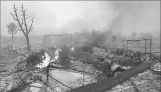  ?? JEFF CHIU, THE ASSOCIATED PRESS ?? Flames rise from the remains of a house that burned down in Santa Rosa, Calif., Monday.