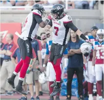  ??  ?? Redblacks wide receiver Ernest Jackson, left, celebrates a touchdown with quarterbac­k Trevor Harris in the second quarter Thursday night.