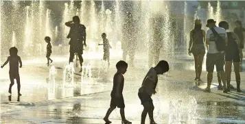  ?? Photo: EP ?? Children play in the water fountains at the Place des Arts in Montreal, Canada, on July 3, 2018.