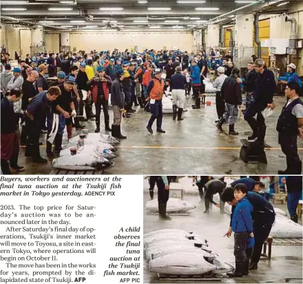  ?? AGENCY PIX AFP PIC ?? Buyers, workers and auctioneer­s at the final tuna auction at the Tsukiji fish market in Tokyo yesterday. A child observes the final tuna auction at the Tsukiji fish market.