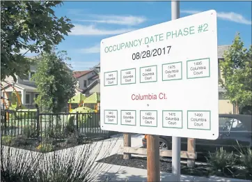  ?? STAFF FILE PHOTO ?? Occupancy dates for University Terrace, a new neighborho­od built by Stanford University, are posted on July 18 in Palo Alto. Despite adding more housing options, school employees live farther away and face longer commutes.