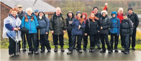  ??  ?? Seasonal spirit Above: Claremont’s long walkers enjoy their day out. Below: Walkers on the alternativ­e route peer through the gloom