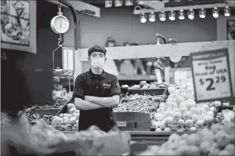  ?? AUTUMN PARRY/THE WASHINGTON POST ?? Jael Marquez, 17, inside the Save A Lot grocery store on May 13 in Denver. Marquez has been working full-time as a produce clerk during the coronaviru­s pandemic.