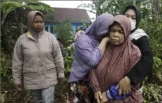  ?? Associated Press ?? Women weep Wednesday as the body of a family member killed in Monday's earthquake is taken away for burial in Cianjur, West Java, Indonesia.