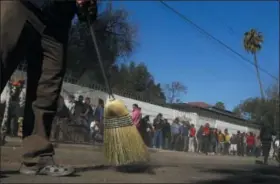  ?? MARCO UGARTE ?? Central American migrants sweep outside the shelter where they are staying in Tijuana, Mexico, Sunday, Nov. 18, 2018. Protesters accused the migrants of being messy, ungrateful and a danger to Tijuana; complained about how the caravan forced its way into Mexico, calling it an “invasion,” and voiced worries that their taxes might be spent to care for the group as they wait possibly months to apply for U.S. asylum. (AP Photo/Marco Ugarte)