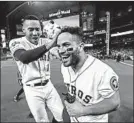  ?? ELSA/GETTY ?? Carlos Correa congratula­tes Jose Altuve after the second baseman’s walk-off, two-run home run Sunday night.