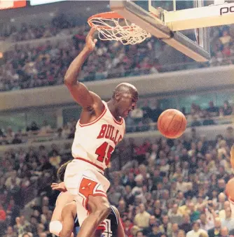  ?? FRED JEWELL/ASSOCIATED PRESS FILE ?? Michael Jordan, who had just returned to basketball after a year playing minor league baseball, dunks against Cleveland during an April 1995 game in Chicago. That summer he was busy making a movie.