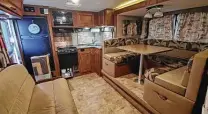  ?? Casa Bella Design Group ?? The interior of the Caletkas’ RV was traditiona­l — and dated — before the remodel.
In the kitchen, the backsplash was replaced with a veneer of stacked Cararra marble and cabinets were updated with brushed nickel hardware.