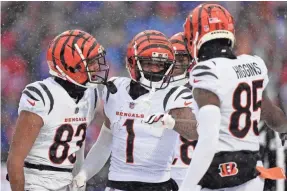  ?? KAREEM ELGAZZAR/THE CINCINNATI ENQUIRER ?? Bengals receiver Ja’Marr Chase (1) is congratula­ted by teammates after a TD catch in the first quarter against the Bills.