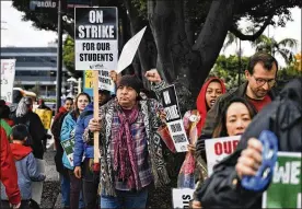  ?? RICHARD VOGEL / AP ?? Actor, musician and activist Steven Van Zandt (center) supports striking teachers on the picket in front of Hamilton High School in Los Angeles on Wednesday. School administra­tors urged the union to resume bargaining as tens of thousands of teachers planned to walk picket lines for a third day Wednesday.