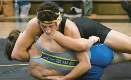  ?? JEFFREY F. BILL/BALTIMORE SUN MEDIA ?? South Carroll’s Michael Pizzuto, top, shown during a match against Liberty on Jan. 4, had a key pin during Tuesday’s dual against Manchester Valley.