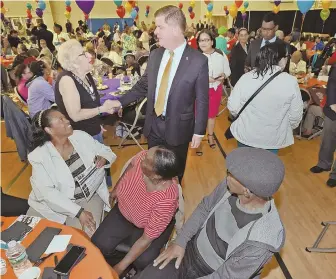  ?? STAFF PHOTOS BY PATRICK WHITTEMORE ?? JOINING THE FESTIVITIE­S: Mayor Martin J. Walsh greets attendees yesterday at the 14th Annual Hispanic Heritage Celebratio­n at the Reggie Lewis Center. At left, Walsh gets some pointers from Carmen Pola of Mission Hill before speaking.