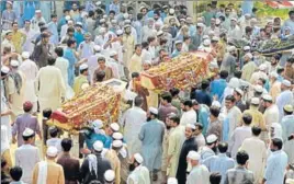  ?? AFP ?? People carry the coffins of those killed in the suicide bombing at an election rally in Peshawar.