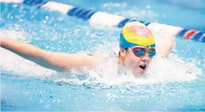  ?? STEPHEN M. DOWELL/ORLANDO SENTINEL PHOTOS ?? Athlete Layla Crehan swims during the Special Olympics Florida 2023 State Aquatics Invitation­al at the Rosen Aquatic Center in Orlando on Friday.