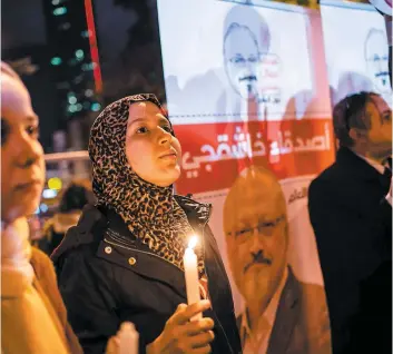  ?? PHOTO AFP ?? Des proches de Jamal Khashoggi se sont réunis hier soir devant le consulat d’arabie saoudite à Istanbul pour réclamer justice et saluer la mémoire du journalist­e tué.