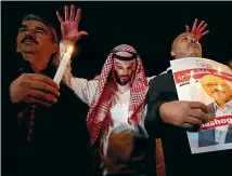  ?? AP ?? An activist, wearing a mask depicting Saudi Crown Prince Mohammed bin Salman, holds up his hands, painted with fake blood as he protests the killing of Saudi journalist Jamal Khashoggi, during a candleligh­t vigil outside Saudi Arabia’s consulate in Istanbul yesterday.