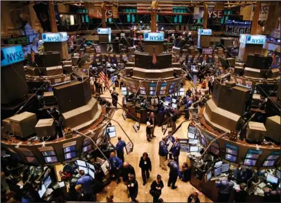  ?? The Associated Press ?? BULL MARKET: In this Nov. 27, 2009, file photo, traders move about the floor of the New York Stock Exchange in New York shortly before the opening bell. The U.S. stock market has been on the upswing for nine and a half years, during which a cohort of younger investors has never dealt with a 20 percent drop in the S&amp;P 500 — the classic definition of a bear market. Such a decline has historical­ly happened on average every four or five years.