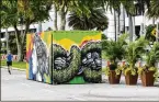  ?? LANNIS WATERS / THE PALM BEACH POST ?? The painted shipping containers that act as barricades to automobile­s have drawn much criticism.