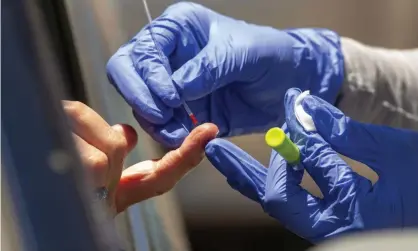  ?? Photograph: Damian Dovarganes/AP ?? A health worker takes a blood sample for a Covid-19 antibody test in Los Angeles.