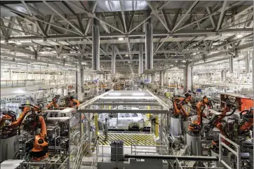  ?? QILAI SHEN — THE NEW YORK TIMES ?? Robotics are a major part of the workplace at a car factory in Hefei, China, and elsewhere around the country. Today, manufactur­ing accounts for a smaller share of the world's output and China already does more than a third of it.