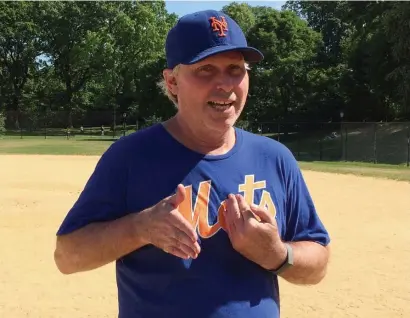  ?? AP ?? ‘FLY IT HIGH’: New York Mets fan Todd Montgomery talks Monday in New York about how the 2020 MLB season would count, no matter how few games are played. Below, fans cheer as Milwaukee’s Christian Yelich walks off the field after driving in the winning run against the Cubs last season.