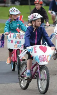  ??  ?? Children in Moncton participat­e in a bike rally as the community starts to pick up the pieces in the aftermath of the multiple-shooting tragedy.