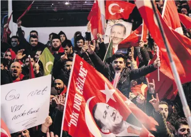  ??  ?? Protesters wave flags and banners with pictures of Turkish President Recep Tayyip Erdogan, outside the Dutch consulate in central Istanbul’s Istiklal Avenue, the main shopping road of Istanbul, early today. A Turkish minister was unable to enter her consulate in the Netherland­s after authoritie­s there had already blocked a visit by the foreign minister.