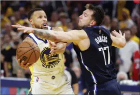  ?? JED JACOBSOHN - THE ASSOCIATED PRESS ?? Golden State Warriors guard Stephen Curry, left, shoots against Dallas Mavericks guard Luka Doncic (77) during the second half of Game 2of the NBA basketball playoffs Western Conference finals in San Francisco, Friday, May 20, 2022.