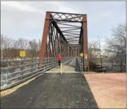  ??  ?? A jogger runs through the Black Bridge Trail on Friday afternoon.