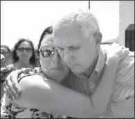  ?? AP/Corpus Christi Caller-Times/RACHEL DENNY CLOW ?? Vice President Mike Pence (left photo) hugs Deidra Cate at a church in Rockport, Texas, on Thursday, where Pence helped with cleanup and vowed to help “bring southeast Texas back bigger and better than ever before.” At right, Mike Cossey of Bureau...