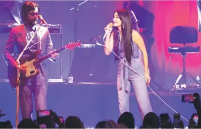  ?? Santiago Mejia / The Chronicle ?? Kacey Musgraves performs with her lead guitarist, Kyle Ryan, at the Masonic. The singer, who won four Grammy Awards this month, spent plenty of time shooting the breeze and reveling in the unexpected success of her latest release, 2018’s “Golden Hour.”