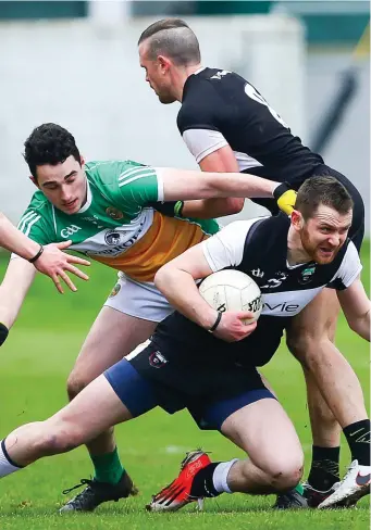  ??  ?? Criostoir Davey of Sligo in action with Offaly’s Nigel Bracken and Eoin Rigney, with Eoin McHugh in support on Sunday in Tullamore.