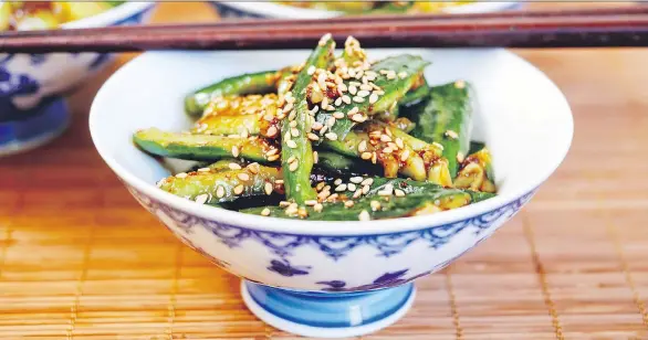  ?? KAREN BARNABY ?? Nothing beats a cool cucumber salad in the summer. This Sichuan version lets you turn up the heat by adding a little — or a lot — of chili oil.