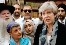  ?? STEFAN ROUSSEAU/POOL PHOTO VIA AP ?? BRITAIN’S PRIME MINISTER THERESA MAY (RIGHT) talks to faith leaders at Finsbury Park Mosque in north London after an incident where a van struck pedestrian­s in the city Monday. British authoritie­s and Islamic leaders moved swiftly to ease concerns in...