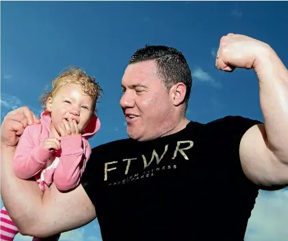  ?? PHOTO: CHRISTEL YARDLEY/FAIRFAX NZ ?? Hamish Coulter’s daughter Bethany, 2, rides in the powerful arms of her father.
