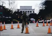  ?? GERALD HERBERT — THE ASSOCIATED PRESS ?? A National Guard stands at a roadblock near the Supreme Court in Washington ahead of President-elect Joe Biden’s inaugurati­on ceremony on Wednesday.