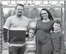  ?? POSTMEDIA NEWS ?? Amber Peters stands with her husband Jeff, six-year-old son Grayson, nine-year-old son Carter, and the Schultz’s future son in a park near their home. Peters said she felt honoured to be a part of the Schultz’s pregnancy journey.