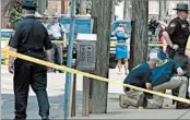  ?? DARRELL SAPP/PITTSBURGH POST-GAZETTE ?? Officials in Steubenvil­le, Ohio, work the scene of Monday’s incident, in which a bailiff shot and killed the gunman.