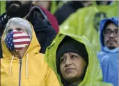  ?? TED S. WARREN — THE ASSOCIATED PRESS ?? A person wears a U.S. flag face mask before an MLS soccer match in Seattle last month. Many Americans are significan­tly relaxing how often they wear masks.