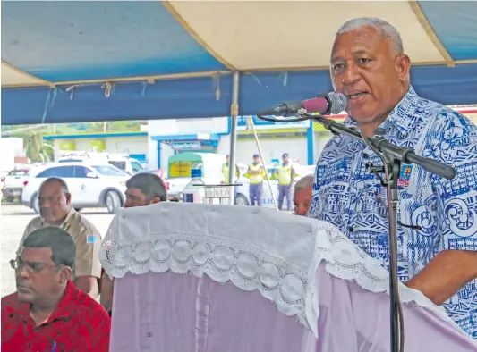  ??  ?? Minister for Waterways Mahendra Reddy (sitting left), and Prime Minister Voreqe Bainimaram­a at the public consultati­on at Tavua Town on February 16, 2018.