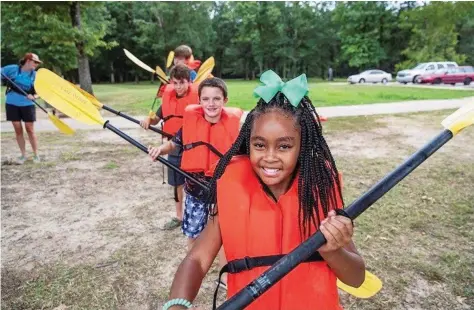  ?? (Special to The Commercial/Mark Matthews) ?? A Boys and Girls Club learns to kayak as part of the Youth Engagement Program of The Nature Conservanc­y in Arkansas.