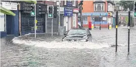  ??  ?? > Flash flooding in Kings Heath, Birmingham, earlier this year