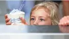  ?? SCOTT ASH/NOW NEWS GROUP ?? Maggie Sitzberger, 5, carefully picks up her sundae. Culver’s small batches of fresh custard are churned out by a machine that’s in full view of customers.