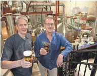  ?? MICHAEL SEARS / MILWAUKEE JOURNAL SENTINEL ?? Russ Klisch (left) and his brother Jim Klisch raise a toast at Lakefront Brewery. The brothers were two of Lakefront’s three founders. Today, Russ is the sole owner. See more photos at jsonline.com/news.