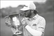  ?? NICK WASS/AP ?? MAX HOMA KISSES THE TROPHY after winning the Wells Fargo Championsh­ip tournament on Sunday at TPC Potomac at Avenel Farm golf club in Potomac, Md.